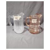 Two glass pitchers, one crystal, one pink