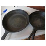 Two Cast Iron Skillets Marked 5Y and 8