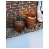 stack of flower pots terra cotta  back porch