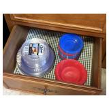 contents of drawer, plastic plates and bowls some