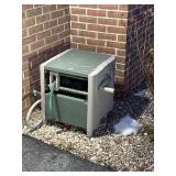 hose reel with hose by garage door