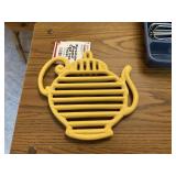 tea pot trivet yellow cast iron, porcelain