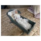 porcelain baby in wooden blue cradle 23.5' long