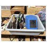 Gray tote with welding helmet and tools