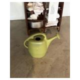 green watering can, plastic    garage