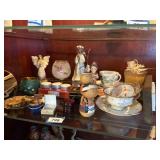 shelf of trinkets, angels, goblet, china cup and