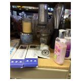 lot of candles, lotions, diffuser, candle holders