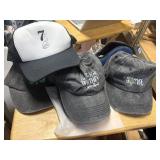 5 baseball caps, 1 blue ear muffs,