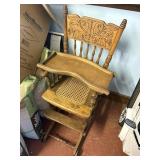 antique wood highchair , cane bottom, on wheels