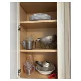 contents in cabinet - measuring cups, colander, co