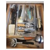 drawer of ladles, slicers, knives, serving spoons