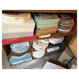 3 shelves of avon and other decorative plates