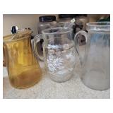3 glass pitchers - 1 amber, 1 cut glass, 1 decal