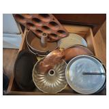 drawer of bundt pans, metal bake king pie pans,