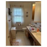 contents of bathroom - wicker hamper, wreath,