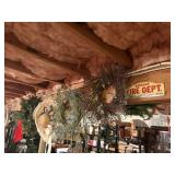 7 wreaths and a hat , on beam in basement