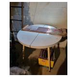 white round dining table with 1 leaf