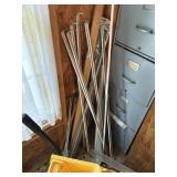 pile of metal curtain rods, various lengths,