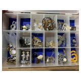organizer full of earrings and pendants, broochs