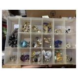 organizer full of earrings, necklace, bracelet,