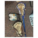 2 lacrosse sticks and 4 new balls in bag