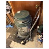large shop vaccum on wheels with handle, hose