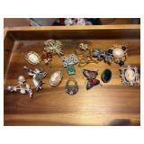 14 brooches, has 3 cameos, some stones, and