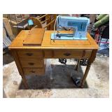blue singer sewing machine in wood cabinet