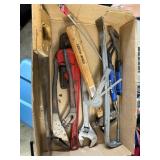 box of pipe wrench, adjustable wrench, saw,