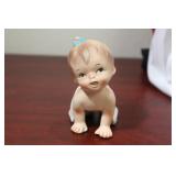 A Ceramic Baby Girl Figurine