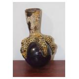 A Metal Eagle Claw Gripping a Glass Ball