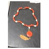 A Cinnabar and Bone Necklace