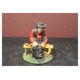 A Cast Iron Sitting Amish Man