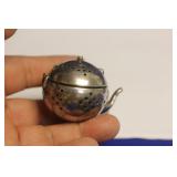 A Sterling Teapot Form Tea Strainer