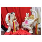 A Boy and Girl on Elephant Statues