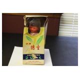 A Vintage Chinese Wooden(?) Doll in Silk Dress