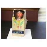 A Vintage Chinese Wooden(?) Doll in Silk Dress