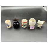 Five toothpick holders in mixed ceramic and...