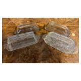 Four Glass Covered Butter Dishes