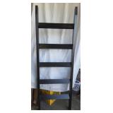 black wooden leaning quilt ladder