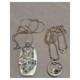 Two decorative stone-set pendants