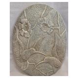 oval decorative wall plaque or garden stone