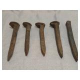 rusted iron railroad spikes