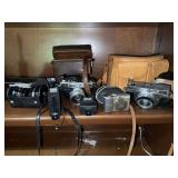 Assorted Vintage Cameras, Bags, & Flashes, Antique Bank Stamp, Projector, and Buckaroo Bank