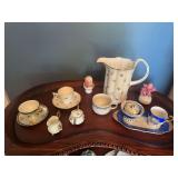 Assorted Tea Cups, Saucers, and Pitcher