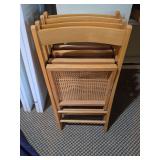 4 Folding Woven Cane Bottom Wooden Chairs - one seat has damage