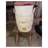Igloo water cooler and wooden bench