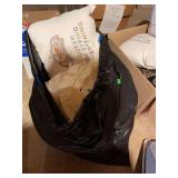 Trash bag full of linens and more