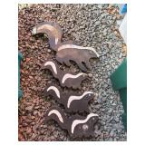 Four Skunk-Shaped Stone Figures