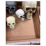 Four Plastic Skull Figures